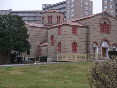 The Byzantine style temple of the Church of the Archangels, with arched windows and terracotta tile roofs.
