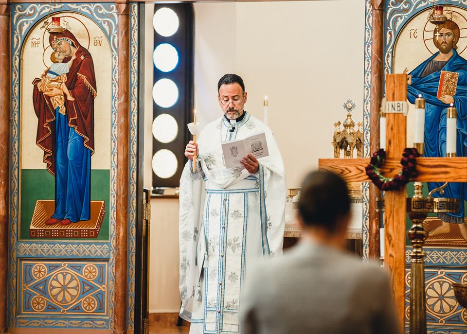 Divine Liturgy at the iconostasis of Archangels Greek Orthodox Church, clergy in gold vestments before the icons.